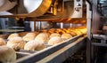 A Conveyor Belt Filled With Assorted Bread Rolls