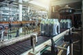 Conveyor belt or line with packaged juice bottles and ready to delivery or shipment on beverage factory equipment