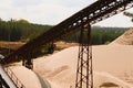 Conveyor belts and sand heaps. Construction industry. Sand quarry. Horizontal photo. Royalty Free Stock Photo