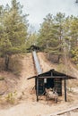 Conveyor elevator from logs in the wilderness - raw material delivery belt at the mine