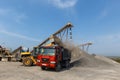 Conveyor feeds crushed natural stone into a truck body in a sand pit Royalty Free Stock Photo