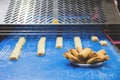 Conveyor for making biscuits, ready-made biscuits on plate