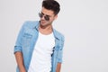 Convinced fashion man looking away while wearing sunglasses Royalty Free Stock Photo