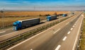 Convoy of Blue transportation trucks in line on a countryside highway