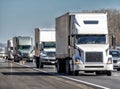 Convoy of Eighteen Wheeler Trucks on Interstate Highway