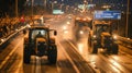 A convoy of tractors with activated lights participating in a rally on a busy urban road.