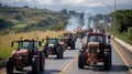 A convoy of tractors with activated lights participating in a rally on a busy urban road.