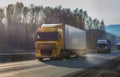 Convoy of trucks moves at dawn along the highway