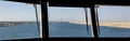Convoy of vessels transiting through the Suez Canal, North bound, Seen through ship\'s wheelhouse window