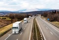 Convoy of White Trucks Or Traction Units In Motion On Highway