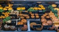 Close-up view of a butcher shop showcase with a variety of steak and pork pies