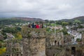 Conwy, Wales; 10/14/2018: Tourists on a tower of Conwy Castle, an ancient 13th Century stone built fortification in North Wales,