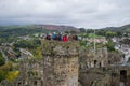 Conwy, Wales; 10/14/2018: Tourists on a tower of Conwy Castle, an ancient 13th Century stone built fortification in North Wales,