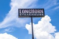 LongHorn Steakhouse sky sign with a blue sky and clouds Royalty Free Stock Photo