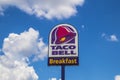 Taco Bell fast food street sign puffy white clouds blue sky Royalty Free Stock Photo