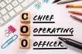 COO - Chief Operating Officer. Computer keyboard and office supplies on a white background