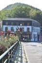 Coo, Belgium - 10 10 2023: Beautiful hotel behind a flower covered bridge