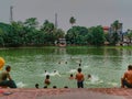 27.05.2022 coochbehar west bengal india, morning view of artificial lake with swimming people in west bengal