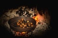 Coocking chestnuts on burning coals Royalty Free Stock Photo