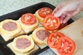 Cook adds tomato on stuffed vegetable marrow Royalty Free Stock Photo