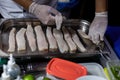 Cook arranging fish on a tray