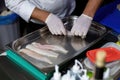 Cook arranging fish on a tray