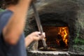 Cook baking pizza in a traditional oven