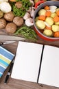 Cook book with vegetables and casserole dish Royalty Free Stock Photo