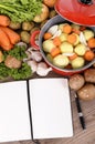 Cook book with vegetables and casserole dish Royalty Free Stock Photo