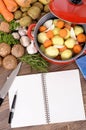 Cook book with vegetables and casserole dish Royalty Free Stock Photo