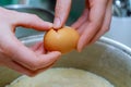 Cook breaking an egg into the bowl in a bakery Royalty Free Stock Photo