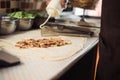 Cook chapati. Preparation of traditional shawarma and shawarma doner kebab. A man pours sauce on pita bread with meat and tomato