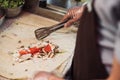 cook chapati. Preparation of traditional shawarma and shawarma & x28;doner kebab& x29;. A man lays out tomatoes, meat on pita.