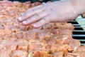 The cook checks the temperature over the barbecue. Cooking. Man`s hands over barbecue grill. Close-up Royalty Free Stock Photo