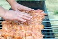 The cook checks the temperature over the barbecue. Cooking. Man`s hands over barbecue grill. Close-up Royalty Free Stock Photo