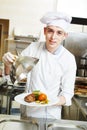 Cook chef with food in kitchen Royalty Free Stock Photo
