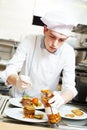 Cook chef with food in kitchen Royalty Free Stock Photo