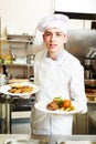 Cook chef with food in kitchen Royalty Free Stock Photo