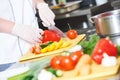 Cook chef hand preparing salad food in kitchen Royalty Free Stock Photo