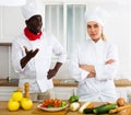 Cook and chef having quarrel in kitchen Royalty Free Stock Photo