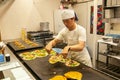 Cook chef preparing okonomiyaki on hot plates in Gion, Kyoto, Japan