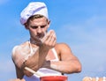 Cook or chef with muscular shoulders and chest covered with flour. Chef cook preparing dough for baking with flour Royalty Free Stock Photo