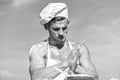 Cook or chef with muscular shoulders and chest covered with flour. Chef cook preparing dough for baking with flour Royalty Free Stock Photo