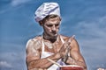 Cook or chef with sexy muscular shoulders and chest covered with flour. Chef cook preparing dough for baking with flour