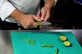 The cook chopping asparagus. Chopping vegetables with a knife