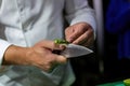 The cook chopping asparagus. Chopping vegetables with a knife