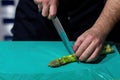 The cook chopping asparagus. Chopping vegetables with a knife