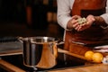 Cook cooking ingredients in a large pot in a kitchen with an array of a equipment