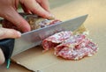 Cook cut the genuine salami Royalty Free Stock Photo