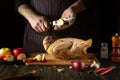 The cook cuts apples to add to raw duck before frying. Cooking a national dish or Peking duck in the restaurant kitchen by the